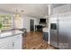 Open-concept living space featuring hardwood floors and a view of the dining area and front entry at 201 Easy St, Concord, NC 28027