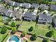 Aerial view showcasing backyard, patio, and a refreshing swimming pool surrounded by lush landscaping in a neighborhood at 2025 Masons Bend Dr, Fort Mill, SC 29708
