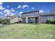 Spacious backyard showcasing a covered patio, lush green lawn, and an inviting outdoor living space at 2025 Masons Bend Dr, Fort Mill, SC 29708