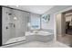 Contemporary bathroom featuring a glass-enclosed shower and a soaking tub at 2025 Masons Bend Dr, Fort Mill, SC 29708