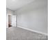 Spacious bedroom with neutral colors, carpet flooring, and a walk-in closet at 2025 Masons Bend Dr, Fort Mill, SC 29708