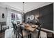 Dining room with a decorative black accent wall, a dining table, and a large window at 2025 Masons Bend Dr, Fort Mill, SC 29708