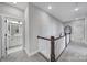 Bright hallway featuring a carpeted floor and a staircase with white railings at 2025 Masons Bend Dr, Fort Mill, SC 29708