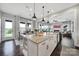 Open kitchen with a granite island, stainless steel appliances, and view into the Gathering room at 2025 Masons Bend Dr, Fort Mill, SC 29708