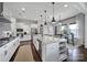 Modern kitchen featuring an island, white cabinets, stainless steel appliances and hardwood floors at 2025 Masons Bend Dr, Fort Mill, SC 29708