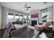 Spacious living room with a fireplace, large sectional sofa, and expansive windows for natural light at 2025 Masons Bend Dr, Fort Mill, SC 29708
