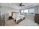 Spacious main bedroom featuring a tray ceiling, ceiling fan, and large window offering lots of natural light at 2025 Masons Bend Dr, Fort Mill, SC 29708