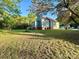 Wide shot of a large backyard with mature trees and the house in the background at 222 Brevard St, Statesville, NC 28677