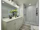 Bright, renovated bathroom with double vanity and patterned floor at 222 Brevard St, Statesville, NC 28677