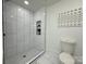 Renovated bathroom featuring a tiled shower with a tiled floor at 222 Brevard St, Statesville, NC 28677