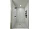 Recently renovated bathroom with a tiled shower, dark fixtures and shelves at 222 Brevard St, Statesville, NC 28677