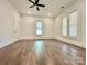Large bedroom featuring wood-look floors, ceiling fan, and natural light at 222 Brevard St, Statesville, NC 28677