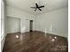 Bright bedroom featuring wood-look floors, a ceiling fan, and a closet system at 222 Brevard St, Statesville, NC 28677