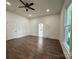 Airy bedroom with ceiling fan and wood floors, featuring ensuite access at 222 Brevard St, Statesville, NC 28677
