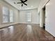A bright bedroom with hardwood floors, white walls, ceiling fan and large windows at 222 Brevard St, Statesville, NC 28677