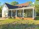 Lovely home with a large front porch, classic columns, green siding, and a well-manicured lawn at 222 Brevard St, Statesville, NC 28677