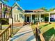 Charming home with green siding, inviting porch, and walkway, plus a welcome sign, all under a sunny, blue sky at 222 Brevard St, Statesville, NC 28677