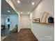 Hallway with hardwood floors, recessed lighting, and decorative wall shelf enhancing the transitional space at 222 Brevard St, Statesville, NC 28677