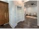 Hallway with wood floors and hall closet that leads to a bright living space with seating and a ceiling fan at 222 Brevard St, Statesville, NC 28677