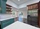 Bright eat-in kitchen features stainless appliances and view into a bright dining space and back deck at 222 Brevard St, Statesville, NC 28677