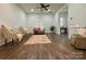 Inviting living room with a ceiling fan, neutral furniture, wainscotting, and wood-look flooring at 222 Brevard St, Statesville, NC 28677