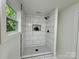 Stylish walk-in shower featuring modern tile, black fixtures, and natural light at 222 Brevard St, Statesville, NC 28677