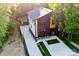 Aerial view of modern home with well-manicured lawn, long driveway, and detached garage at 2224 Highland St, Charlotte, NC 28208