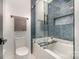Bathroom featuring a bathtub with shower and blue tile accents, with modern fixtures at 2224 Highland St, Charlotte, NC 28208