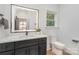 Bathroom boasts a sleek vanity with black fixtures and a well-lit mirror above a white countertop at 2224 Highland St, Charlotte, NC 28208