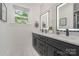 Modern bathroom with a dual sink vanity, quartz countertop, framed mirrors and stylish fixtures at 2224 Highland St, Charlotte, NC 28208