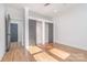 Bedroom with hardwood floors and closet with sliding doors providing ample storage space at 2224 Highland St, Charlotte, NC 28208