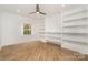 Bedroom with wood floors, built-in bookshelves, and a ceiling fan for comfort at 2224 Highland St, Charlotte, NC 28208