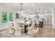Open-concept dining area with modern chandelier and kitchen island at 2224 Highland St, Charlotte, NC 28208