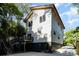 Modern home with white siding, black accents, backyard and staircase to the second story at 2224 Highland St, Charlotte, NC 28208