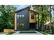 Modern two-story home featuring a black and wood facade, enhanced curb appeal, and neat landscaping at 2224 Highland St, Charlotte, NC 28208