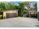 Modern oversized garage with black door and driveway and staircase to the second story at 2224 Highland St, Charlotte, NC 28208
