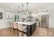 Bright kitchen with white cabinetry, stainless steel appliances, and an island with seating at 2224 Highland St, Charlotte, NC 28208