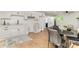 Well-lit kitchen and dining area featuring white cabinets, hardwood floors, and modern decor at 2224 Highland St, Charlotte, NC 28208