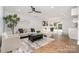 Bright living room with modern decor, wood floors, and sliding glass doors to the outdoor space at 2224 Highland St, Charlotte, NC 28208