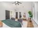 Bright main bedroom featuring closet space, an ensuite bathroom, and a seating area with hardwood floors at 2224 Highland St, Charlotte, NC 28208