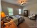 Bedroom featuring neutral walls, ceiling fan, carpeted floors, shutters and furnishings at 2279 Eversham Nw Dr, Concord, NC 28027