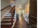 Inviting entryway with hardwood floors, staircase, and view into the home at 2279 Eversham Nw Dr, Concord, NC 28027