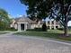 Beautiful building with a stone facade, manicured lawn, and columned entry at 2279 Eversham Nw Dr, Concord, NC 28027