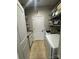 Functional laundry room with ample shelving, a utility sink, and modern appliances at 2279 Eversham Nw Dr, Concord, NC 28027
