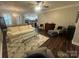 Bright living room with hardwood floors, neutral tones, and open layout to kitchen at 2279 Eversham Nw Dr, Concord, NC 28027