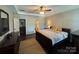 Comfortable main bedroom with tray ceiling, a large window, hardwood floors, and ensuite bathroom at 2279 Eversham Nw Dr, Concord, NC 28027