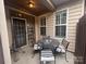 Covered patio with a table and four chairs for outdoor enjoyment and relaxation at 2279 Eversham Nw Dr, Concord, NC 28027
