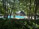 A scenic pool area nestled within lush trees, perfect for relaxation and recreation at 2279 Eversham Nw Dr, Concord, NC 28027