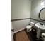 Well-appointed powder room with a modern pedestal sink and stylish decor at 2279 Eversham Nw Dr, Concord, NC 28027