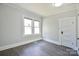 Bright bedroom features wood flooring, a neutral color palette, and natural light from the windows at 2306 W C St, Kannapolis, NC 28081